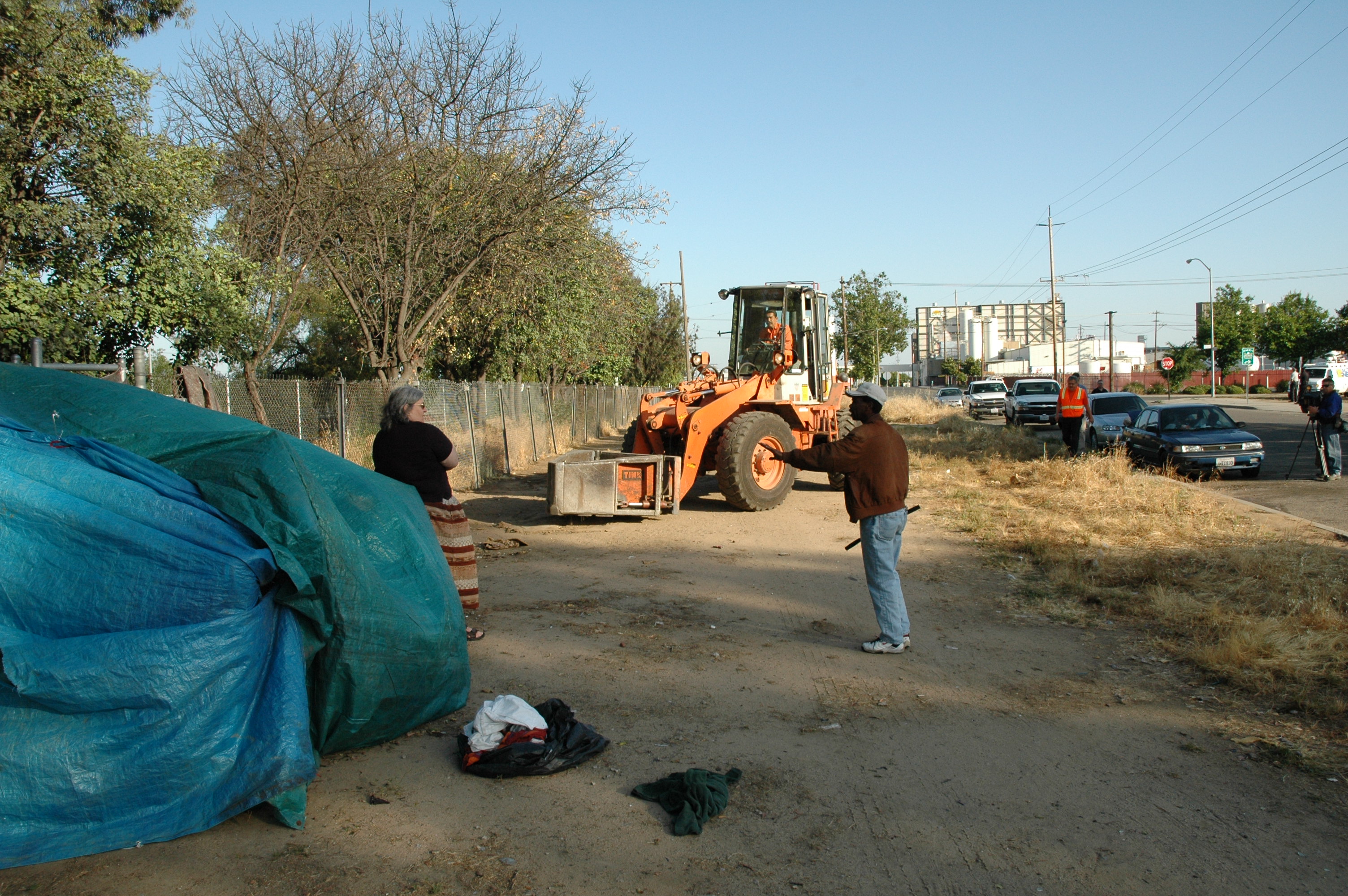Liza Apper (left) stood in front of this tent and refused to allow the bulldozer to destroy it. Shortly after the bulldozer left, Twist (a homeless man) emerged from the tent. He had been sleeping and would have been picked up by the bulldozer, put into a garbage truck and taken to the dump if Liza had not held her ground. Nobody knew that Twist was in the tent until after he came out.